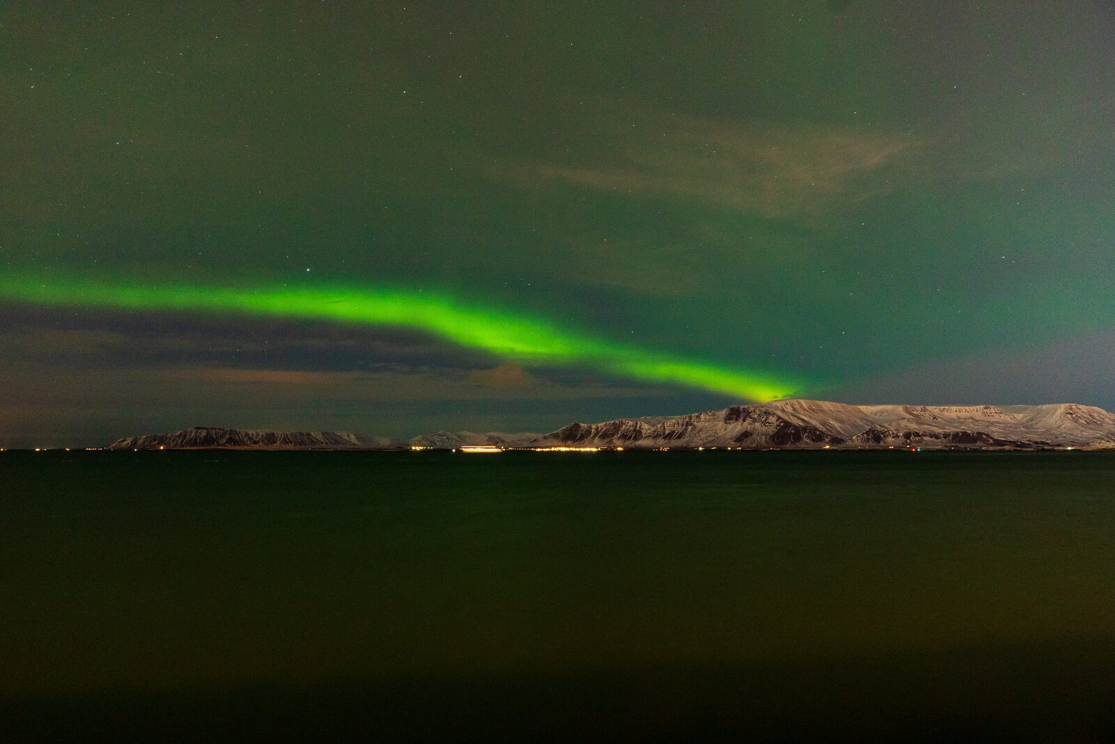 Aurora borealis band over Mount Esja at night